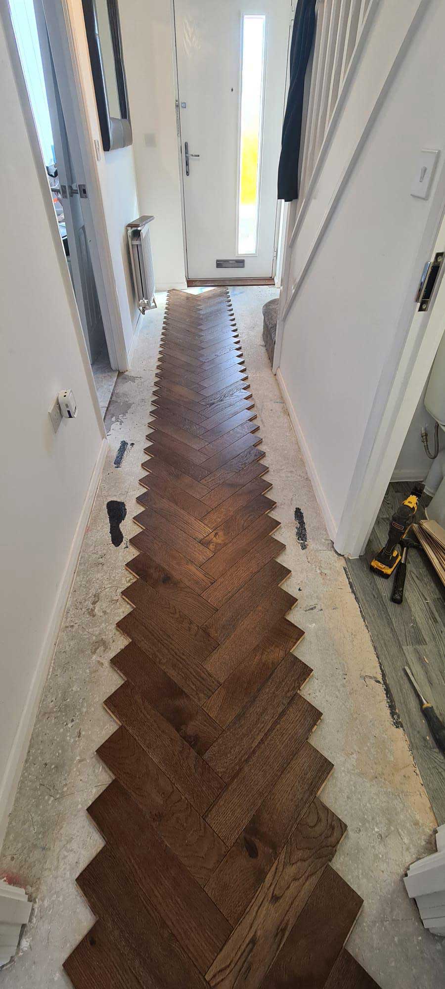 Herringbone parquet flooring being laid