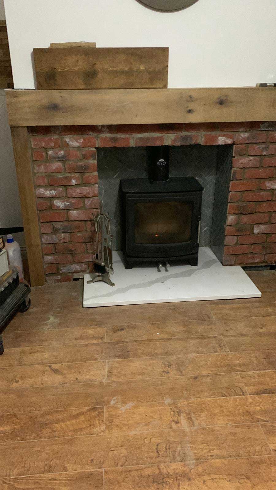 Log burner with brick surround